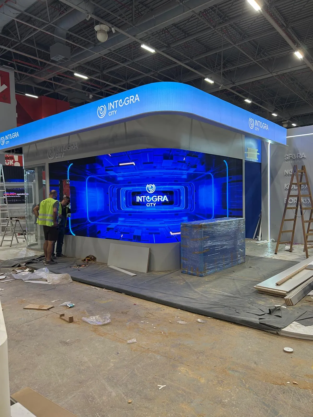 Integra City branding on the curved LED display and upper LED band during installation at GITEX